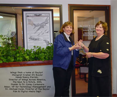 Margaret Kramer, handing Nancy a key to our new office space.